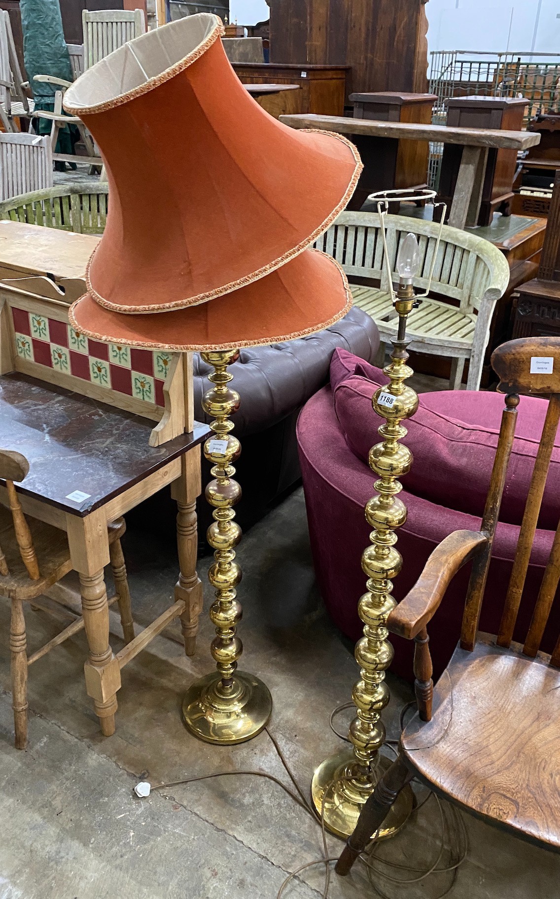 A pair of modern cast metal bobbin stemmed floor lamps